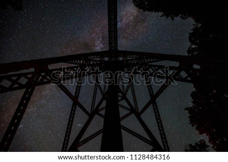 A shot of the milky way with a railroad trestle in the foreground