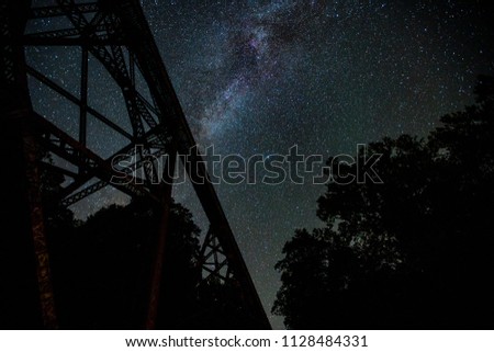 A shot of the milky way with a railroad trestle in the foreground