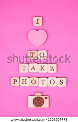 wooden letters, inscription on a bright pink background. International Day of Photography, concept