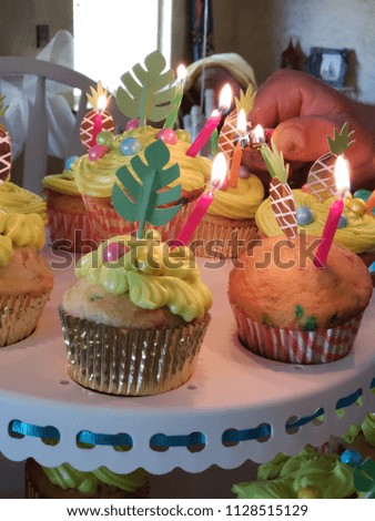Up close cupcakes candles being lit