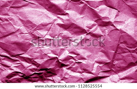 Old crumpled paper with wrinckles in pink color. Abstract background and texture for design.