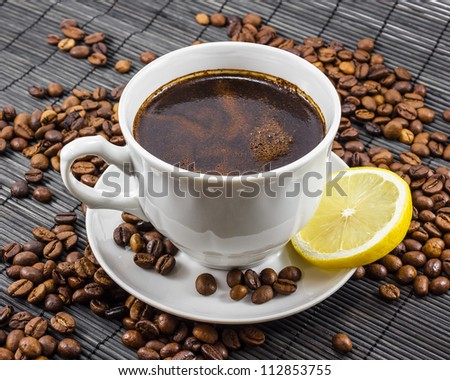 Warm cup of coffee with a coffee beans on background Royalty-Free Stock Photo #112853755