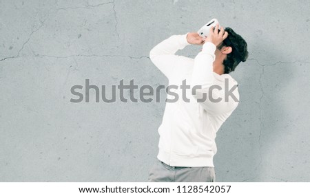 young crazy man with a virtual reallity glasses.full body cutout person against white background