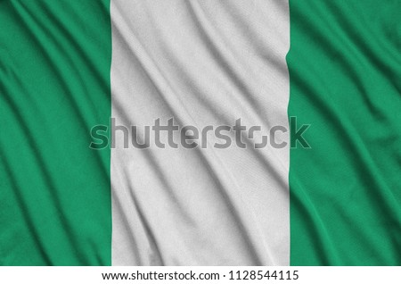 Nigeria flag  is depicted on a sports cloth fabric with many folds. Sport team banner