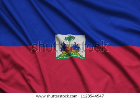 Haiti flag  is depicted on a sports cloth fabric with many folds. Sport team banner