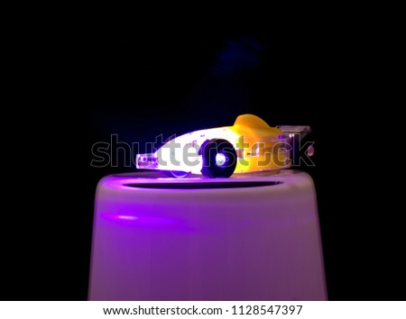 yellow car under purple light