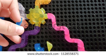 child playing with artistic toys 