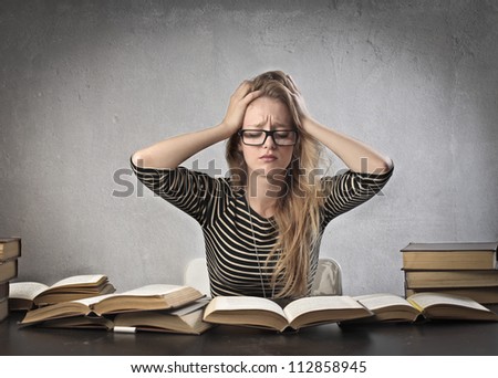 Beautiful blonde girl stressed by the study