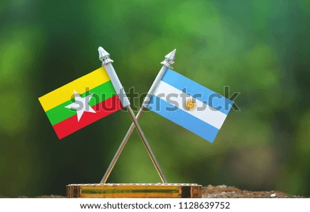 Argentina and Myanmar small flag with blur green background