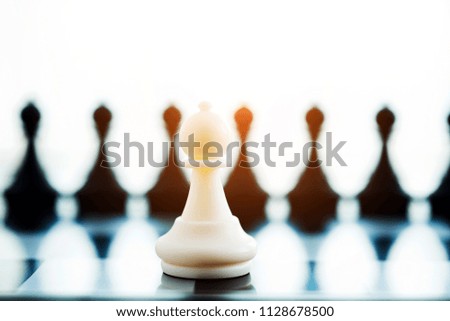 One pawn standing against group black pawn chess.