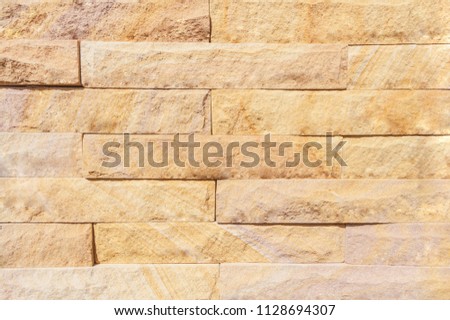 The wall is made of cement and stone.
