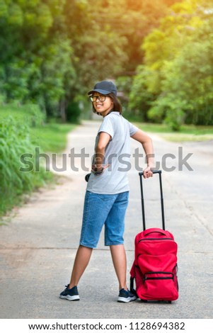 Asian young girl backpacker.Beautiful Asia woman traveler,travel concept.Photo by select focus and soft background.