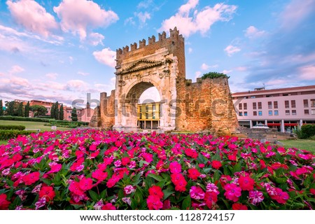 Rimini landmark. Italy. Famous Triumphal Arch in Rimini on blue sky background. Royalty-Free Stock Photo #1128724157