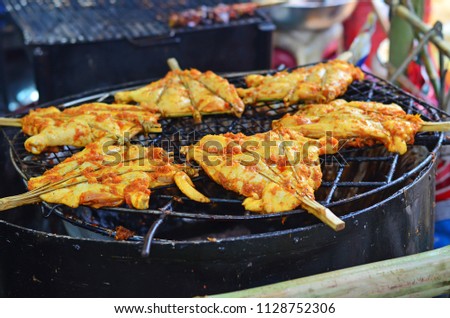 Grilled chicken or roasting chicken at street food market in Thailand