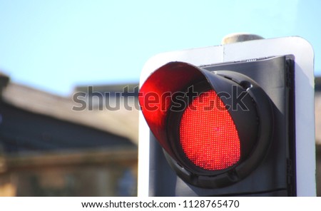 Red stop traffic light in busy finance area of city