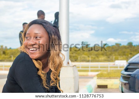 african girl smiling and looking away from the camera. black girl happy and smiling