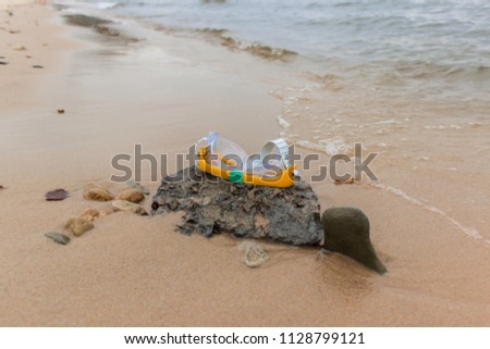 Kid's swimming mask on the sea beach