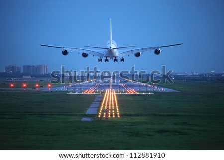 passenger plane fly up over take-off runway from airport Royalty-Free Stock Photo #112881910