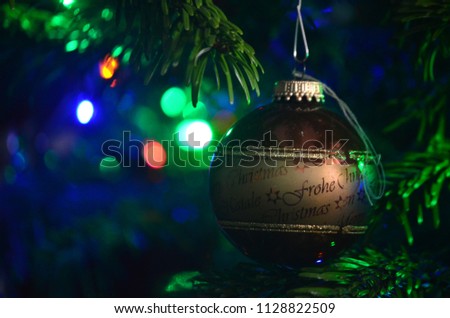 Christmas tree decoration globe hanging on a branch with lights background