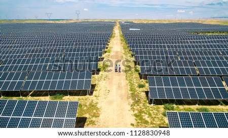 Aerial photography is an Asian engineer inspecting solar photovoltaic districts