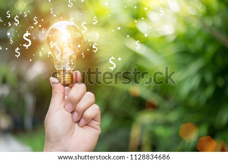 Idea of earning money in  hand business man Royalty-Free Stock Photo #1128834686