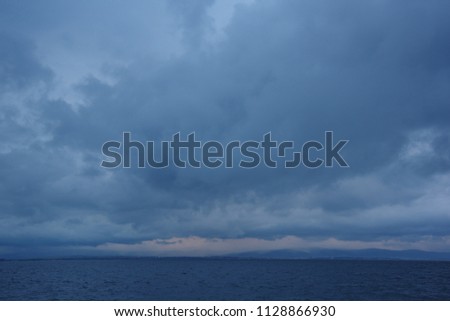 Seascape on the dark clouds background before a thunderstorm
 Royalty-Free Stock Photo #1128866930