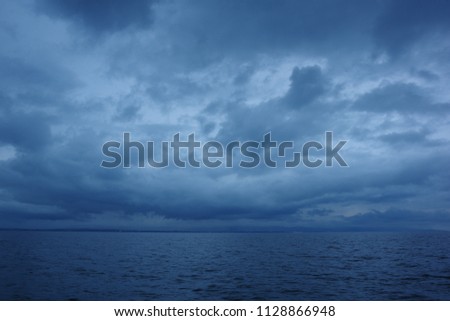 Seascape on the dark clouds background before a thunderstorm
 Royalty-Free Stock Photo #1128866948