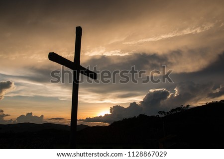 A silhuete cross in the sunset in Ibitipoca, Minas Gerais, Brasil. Church of Our Lady of Conception.