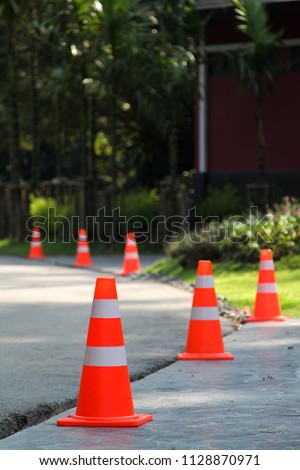 Orange plastic traffic cone on the road.