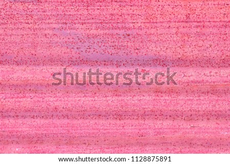The crack and painted peeling pattern of long lines light red old wall, front view, free space for text. Concept background texture of colourful wall.