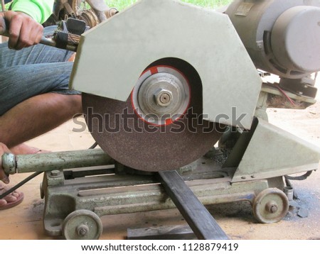 Cutting steel box by mitre saw with circular blade.Steel cutting process concept. 