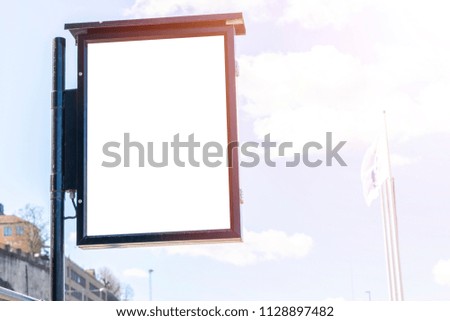 Blank white billboard on city street. In the background street and building. Mock up. Poster on street. Empty space for text. Copy space. Isolated white screen. Mockup for advertising banners.