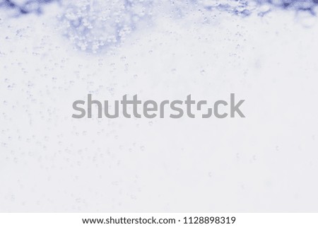 Minimalistic water background with bubbles. Close-up photo.