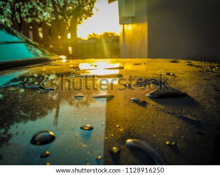 Drop of water in a car sunset