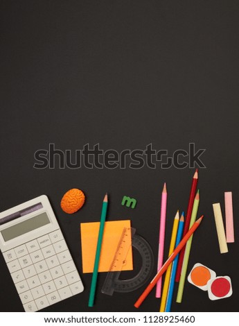 School accessories on blackboard