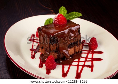 Chocolate cake with raspberry and mint leaves