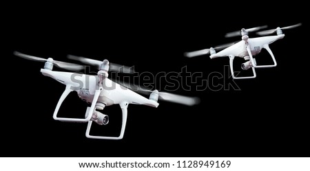 Isolated white drone with twirled propellers on black background Royalty-Free Stock Photo #1128949169