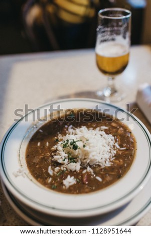 Traditional Creole cajun court bouillon with fish and seafood gumbo chowder stew and beer