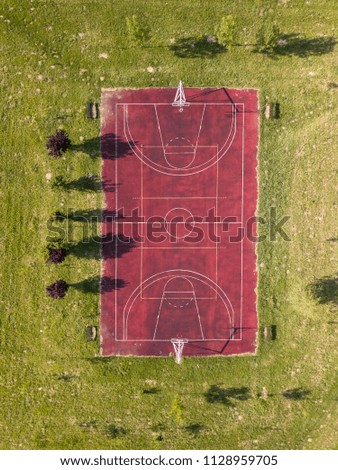 Aerial shot of basketball court on a grassland 