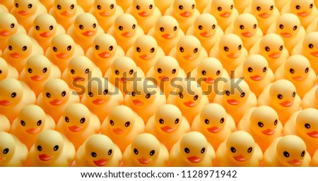a lot of rubber ducks standing in a order