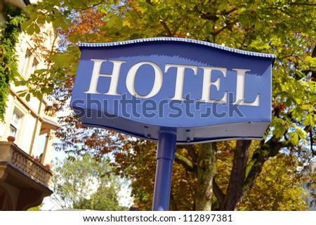 Hotel sign - Hotel signboard with building and trees in the background