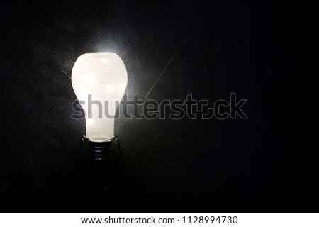 Glowing lightbulb  on black background, idea concept