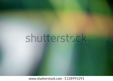 Abstract green, yellow and black blurred background. Horizontal view.