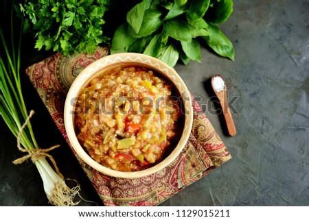Middle Eastern cuisine - babaganush (eggplant caviar) from baked eggplant and pepper, with tomatoes, chili pepper, onion with olive oil and sea salt. Royalty-Free Stock Photo #1129015211