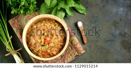 Middle Eastern cuisine - babaganush (eggplant caviar) from baked eggplant and pepper, with tomatoes, chili pepper, onion with olive oil and sea salt. Royalty-Free Stock Photo #1129015214
