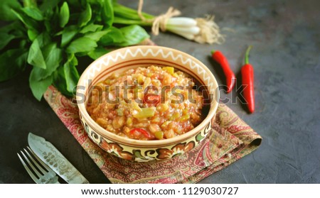 Middle Eastern cuisine - babaganush (eggplant caviar) from baked eggplant and pepper, with tomatoes, chili pepper, onion with olive oil and sea salt. Royalty-Free Stock Photo #1129030727