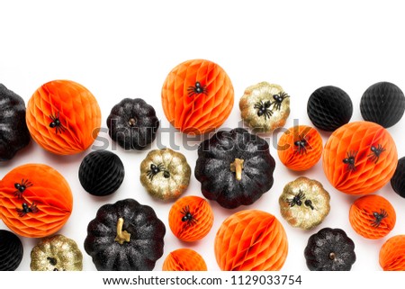 Shiny Decorative Pumpkins and Honeycomb balls. Halloween decorations. Flat lay, top view trendy holiday concept.