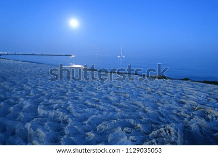 night beach and the sea under the moonlight