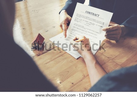 Real estate agents  and client to agree buy a home and sign documents contract house with customer at at their agency's. Agreement concept.