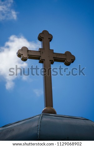 A Church's cross on a blue sky background